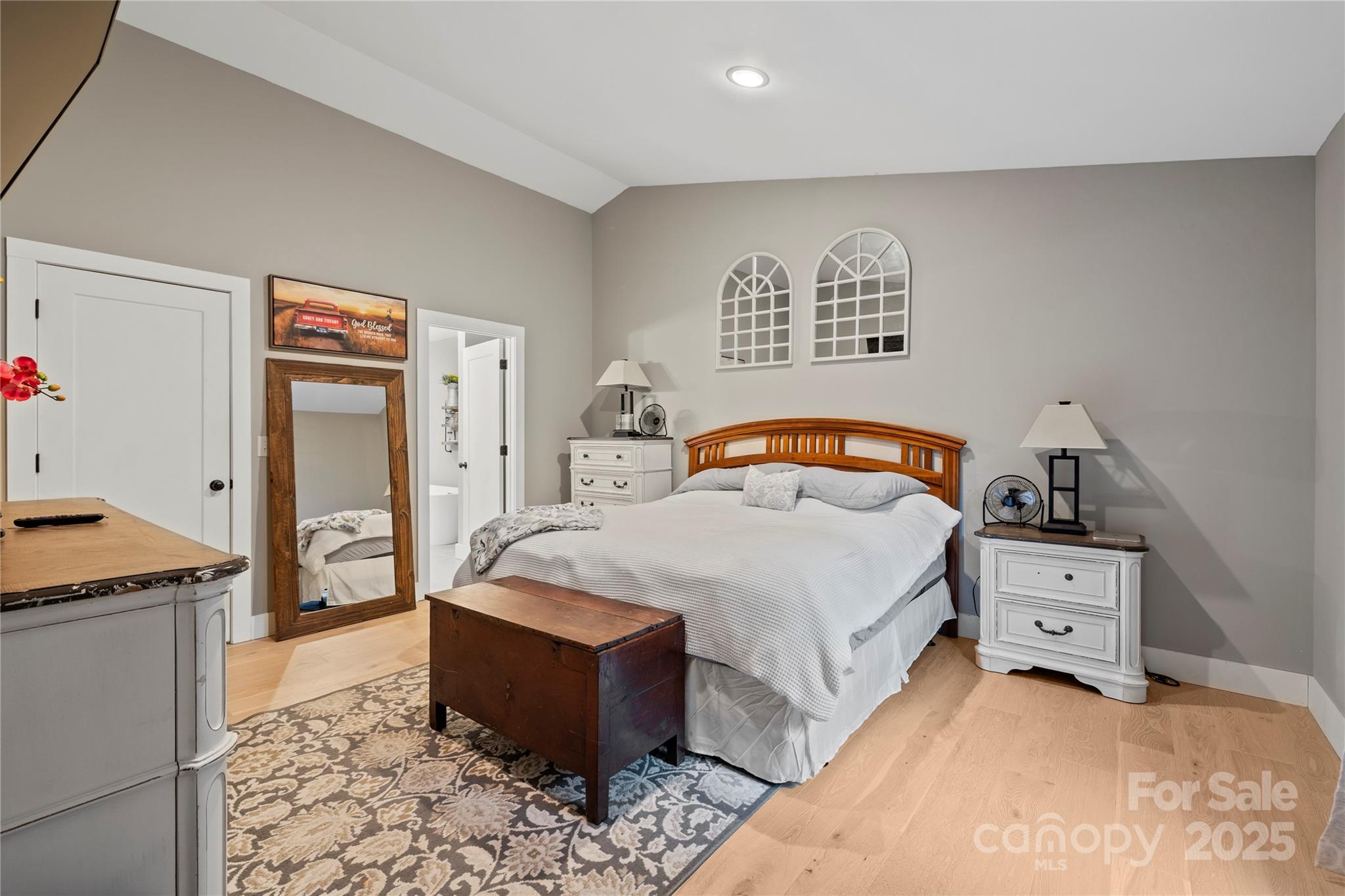 185 Ben Nevis Road Brevard, NC 28712 - Photo 16 of 42 a bedroom with a bed and a lamp on dresser