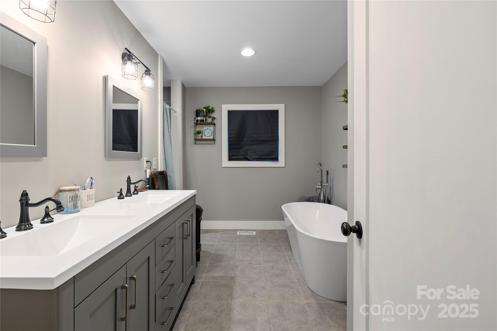 185 Ben Nevis Road Brevard, NC 28712 - Photo 18 of 42 a bathroom with a double vanity sink a toilet and mirror