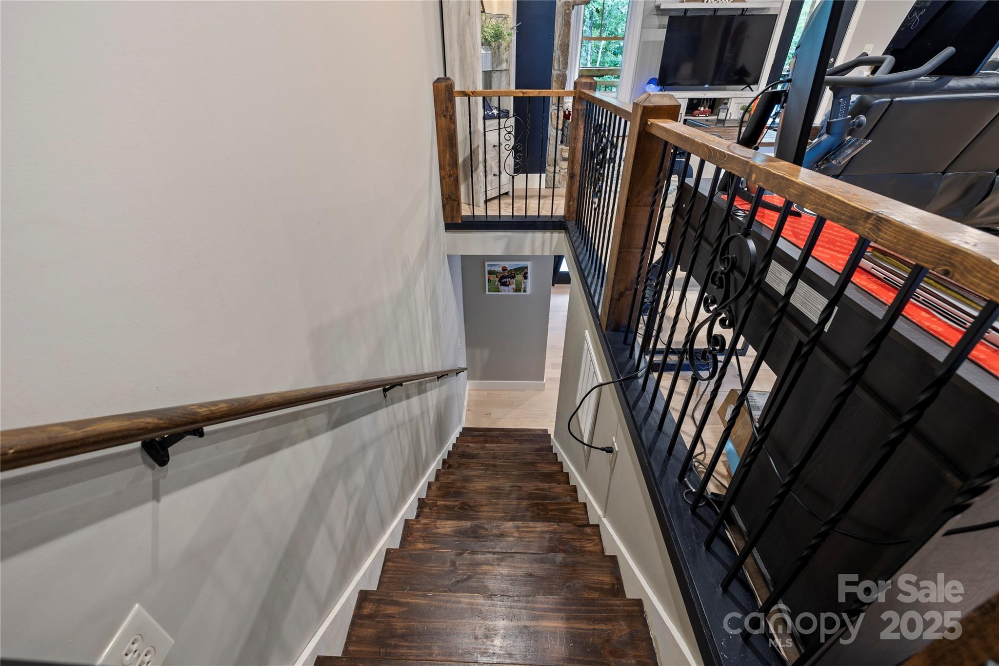 185 Ben Nevis Road Brevard, NC 28712 - Photo 19 of 42 a view of a hallway with wooden floor and stairs