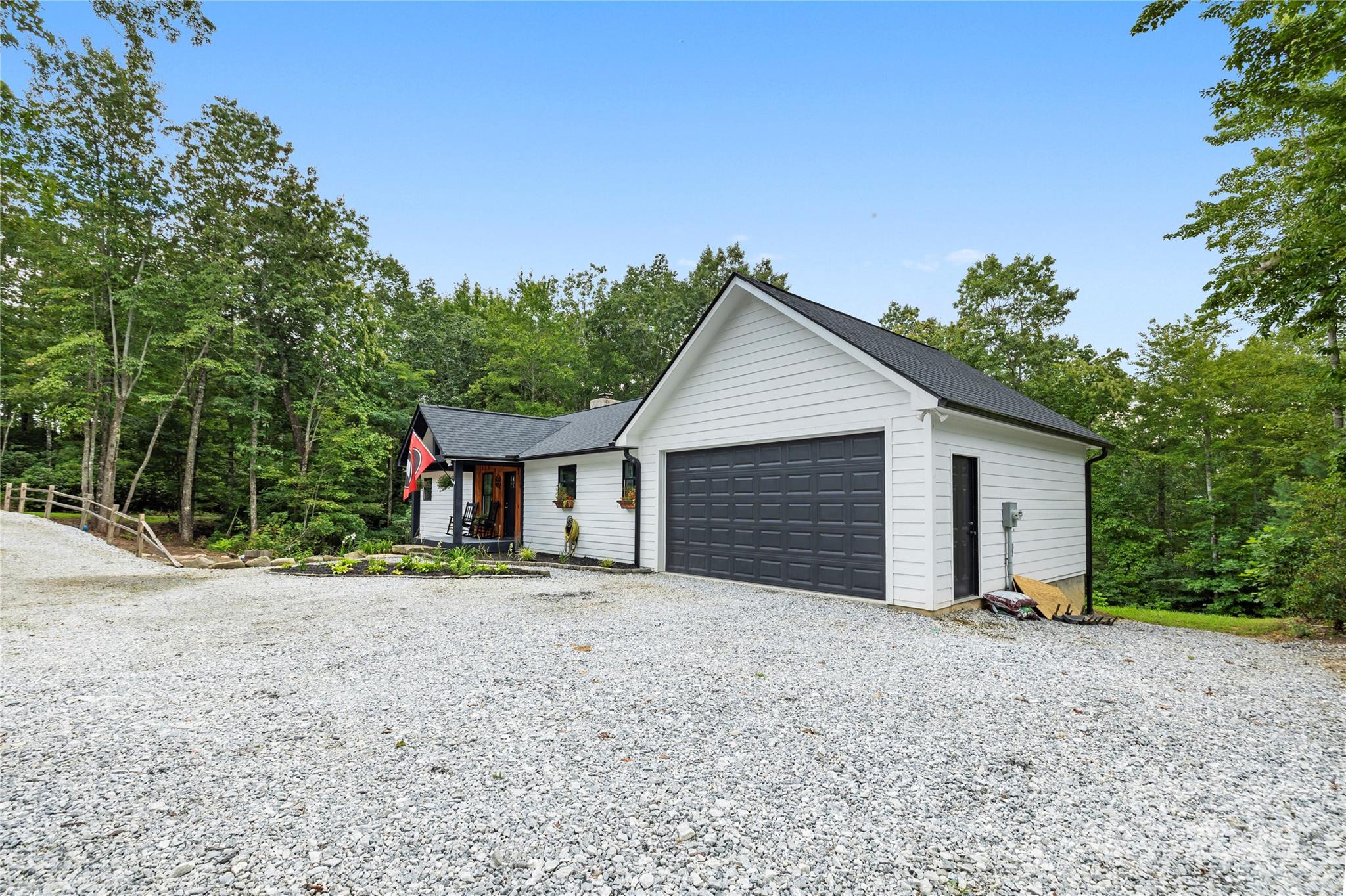 185 Ben Nevis Road Brevard, NC 28712 - Photo 2 of 42 a front view of a house with a yard and garage