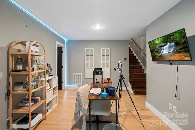 a bedroom with a bed and a flat tv screen on dresser