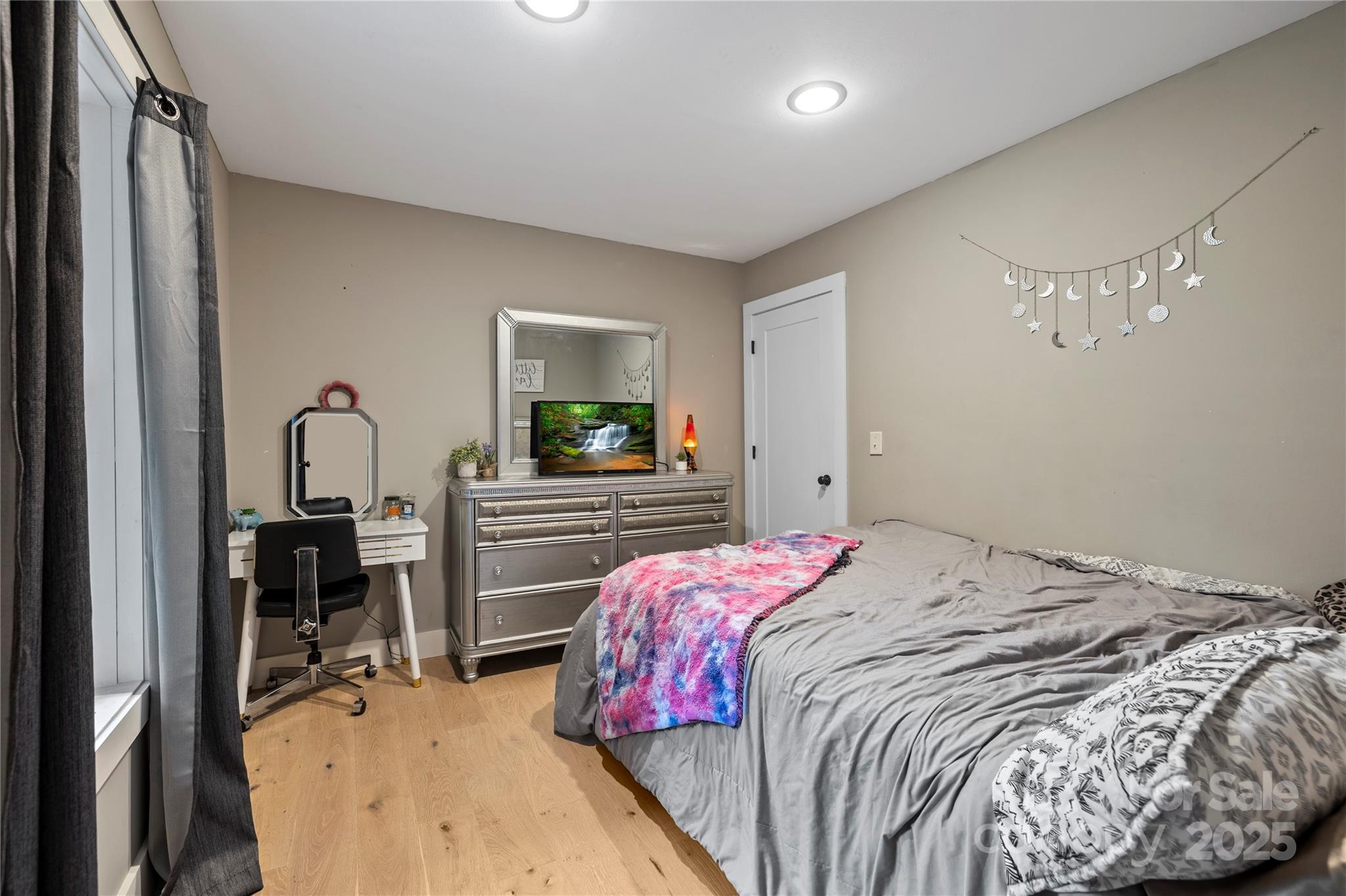 185 Ben Nevis Road Brevard, NC 28712 - Photo 22 of 42 a bedroom with a bed and a flat tv screen on dresser