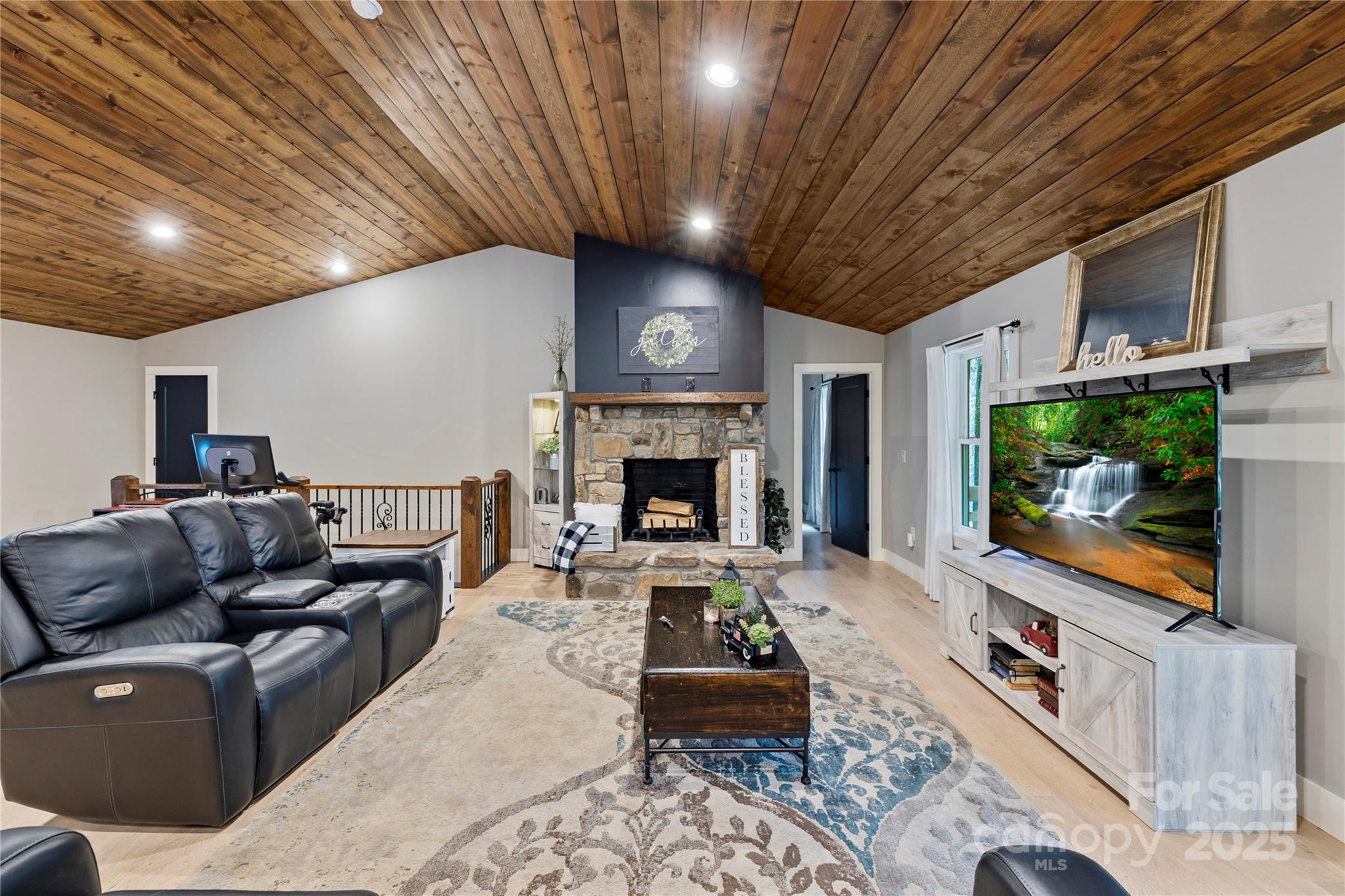 185 Ben Nevis Road Brevard, NC 28712 - Photo 5 of 42 a living room with furniture a flat screen tv and a fireplace