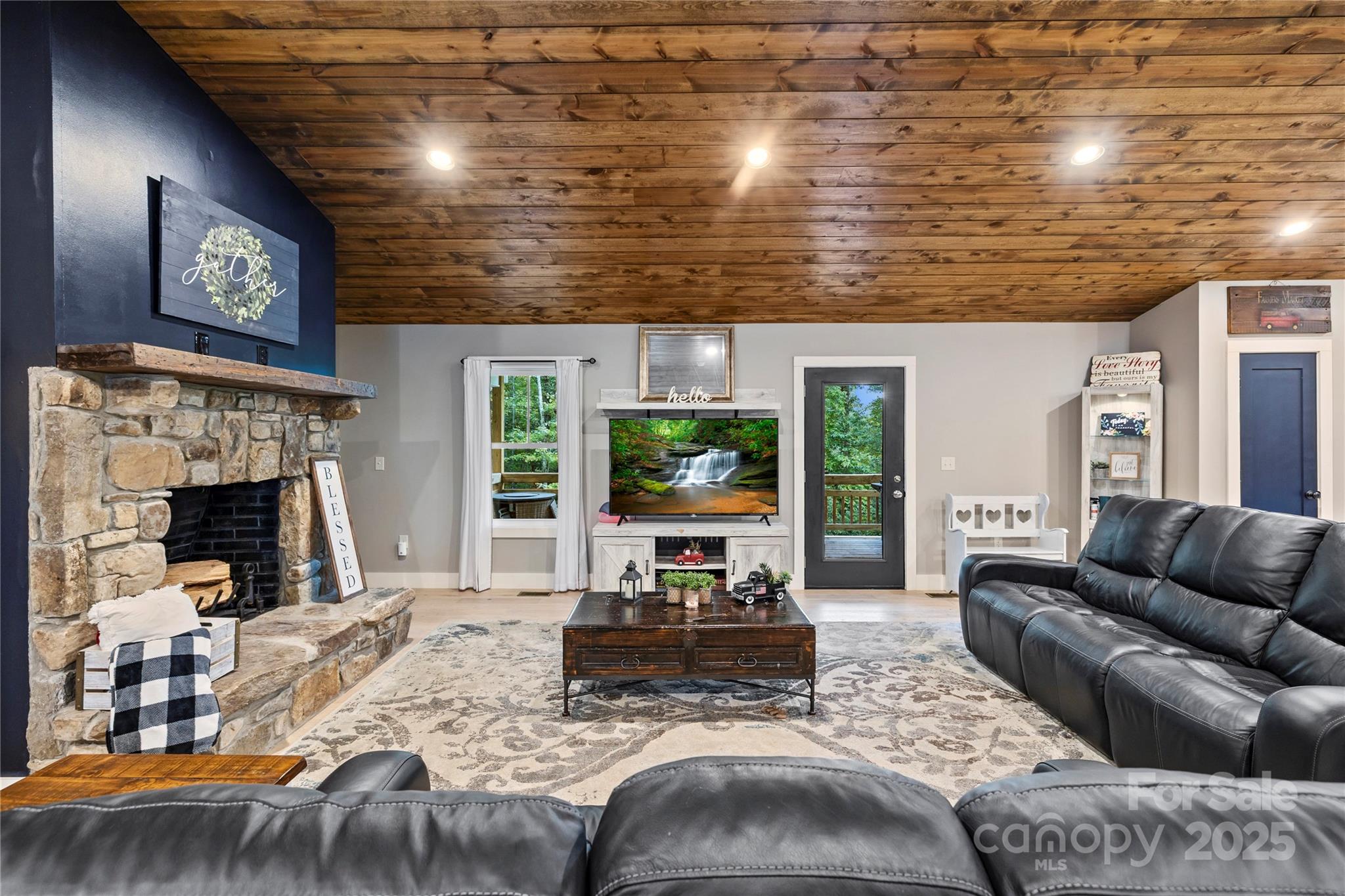 185 Ben Nevis Road Brevard, NC 28712 - Photo 7 of 42 a living room with furniture large window and a fireplace
