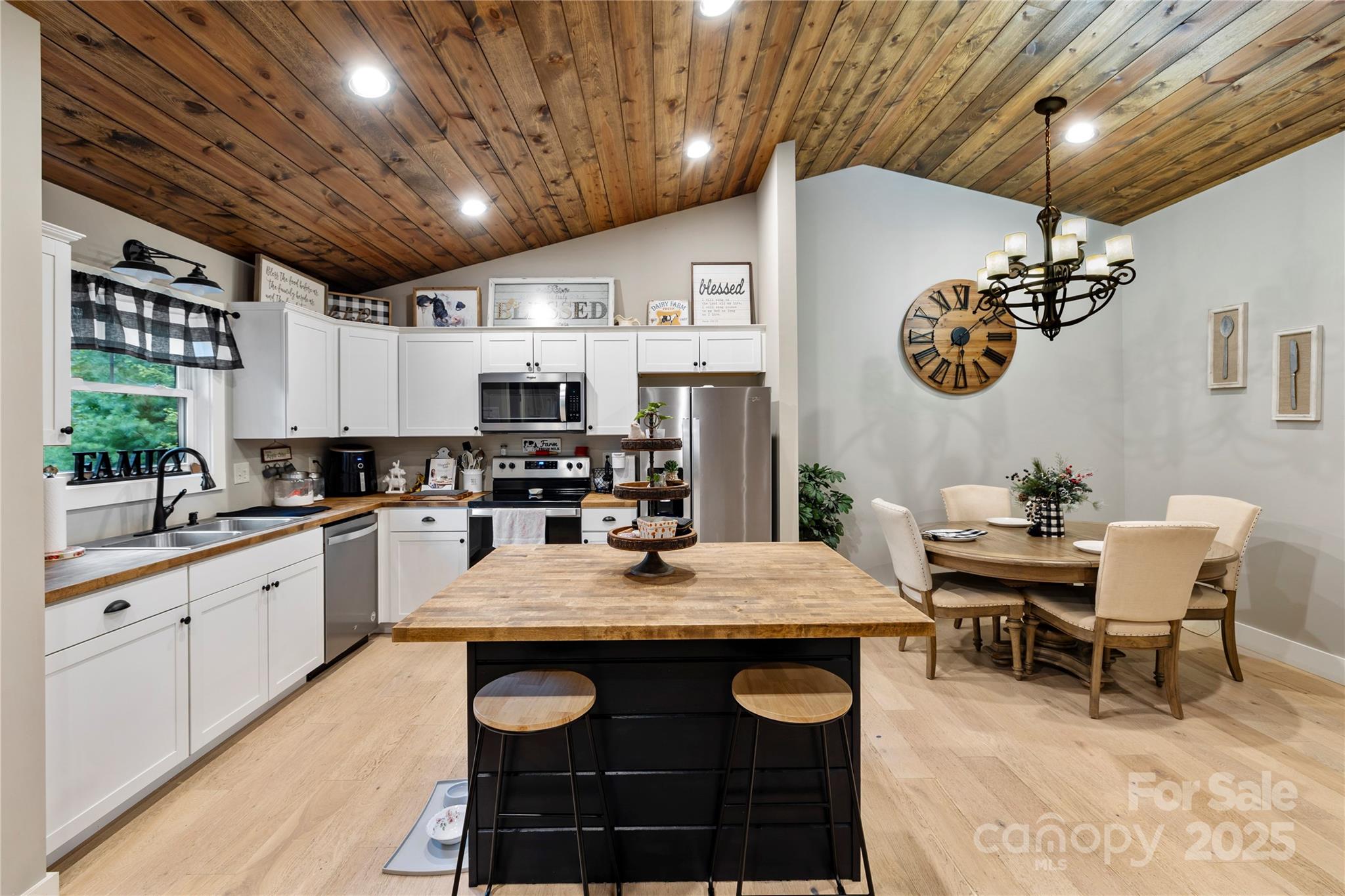 185 Ben Nevis Road Brevard, NC 28712 - Photo 10 of 42 a kitchen with a table chairs stove and cabinets