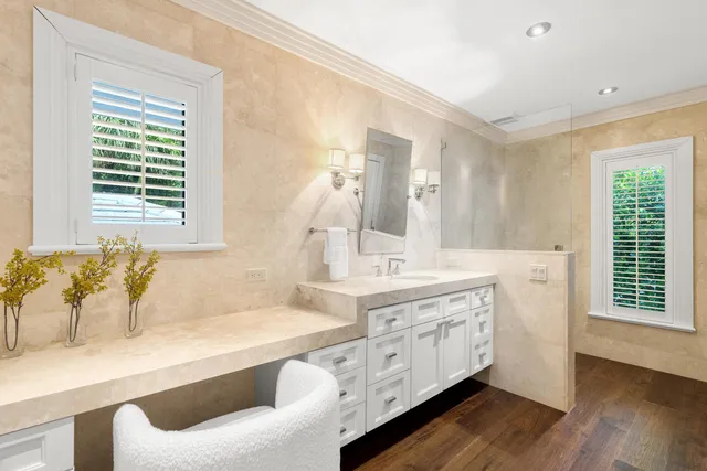 a spacious bathroom with a granite countertop sink and a large mirror