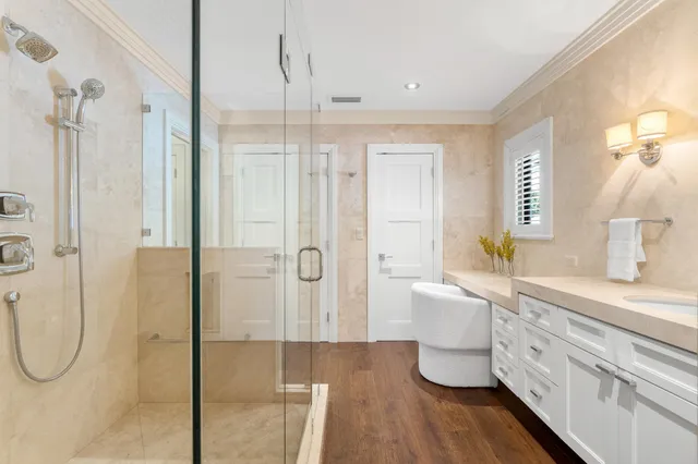a bathroom with a double vanity sink a mirror and shower