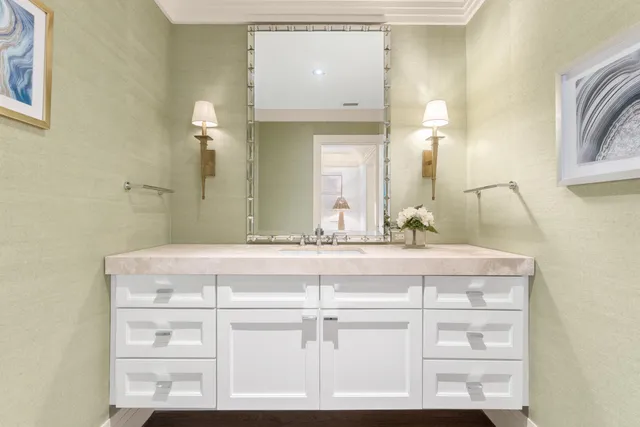 a bathroom with a sink vanity and mirror