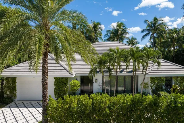 a view of a patio with table and chairs and potted plants