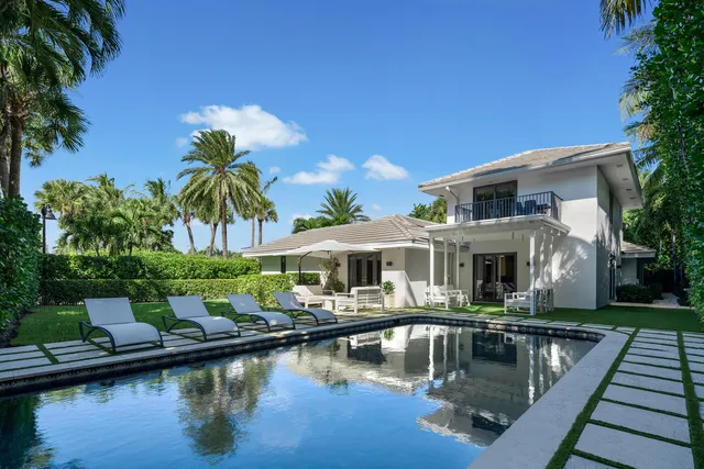 a house with swimming pool in front of it