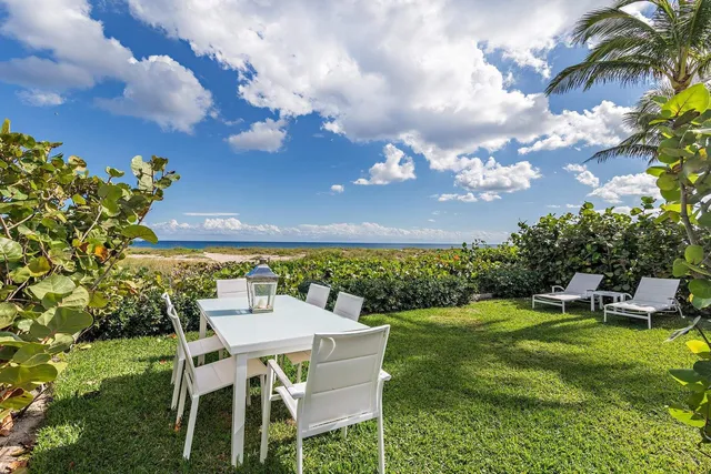 a view of a chairs and table in patio