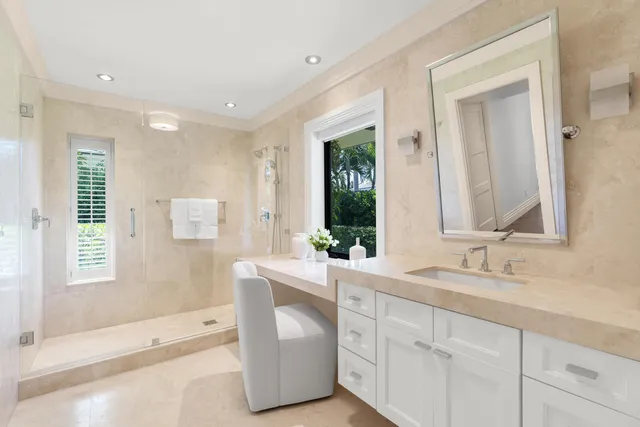 a bathroom with a double vanity sink mirror and bathtub