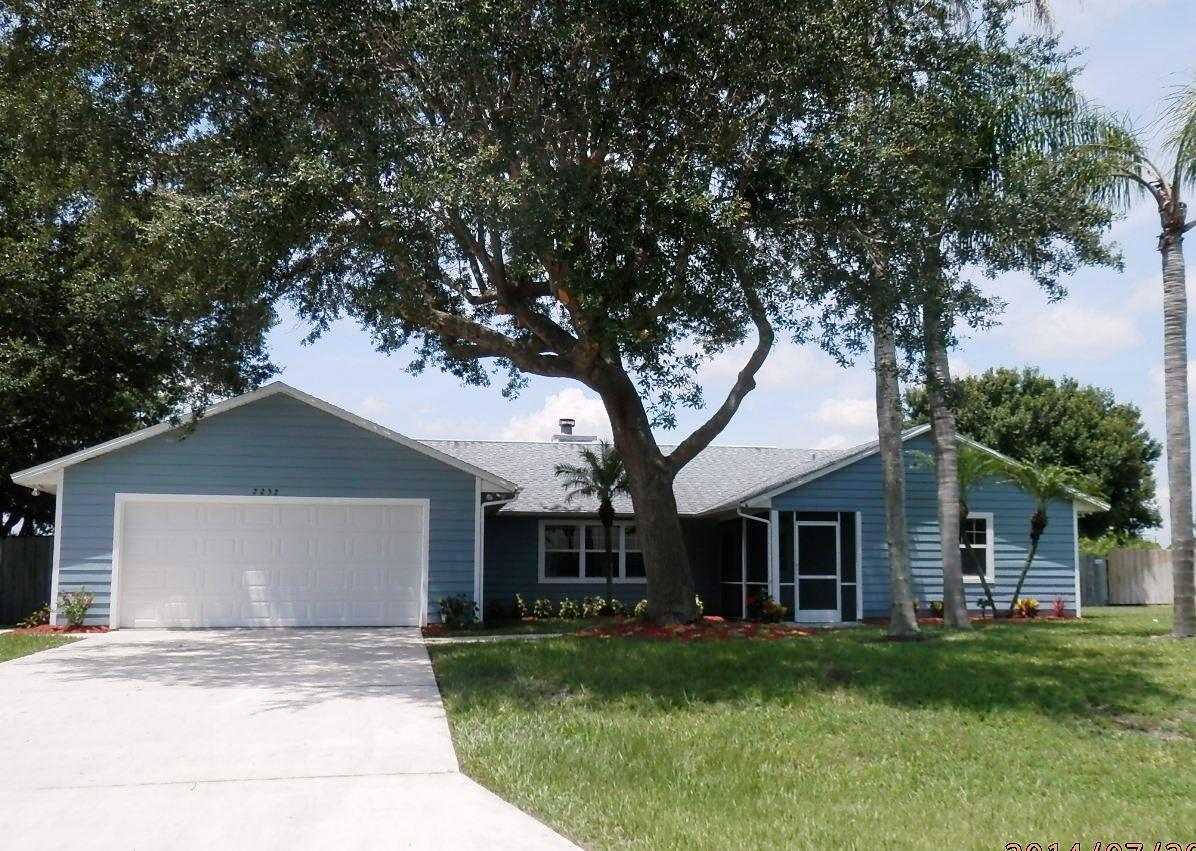 2252 Southeast Flanders Road Port St. Lucie, FL 34952 - Photo 1 of 24 FRONT WITH MATURE TREES