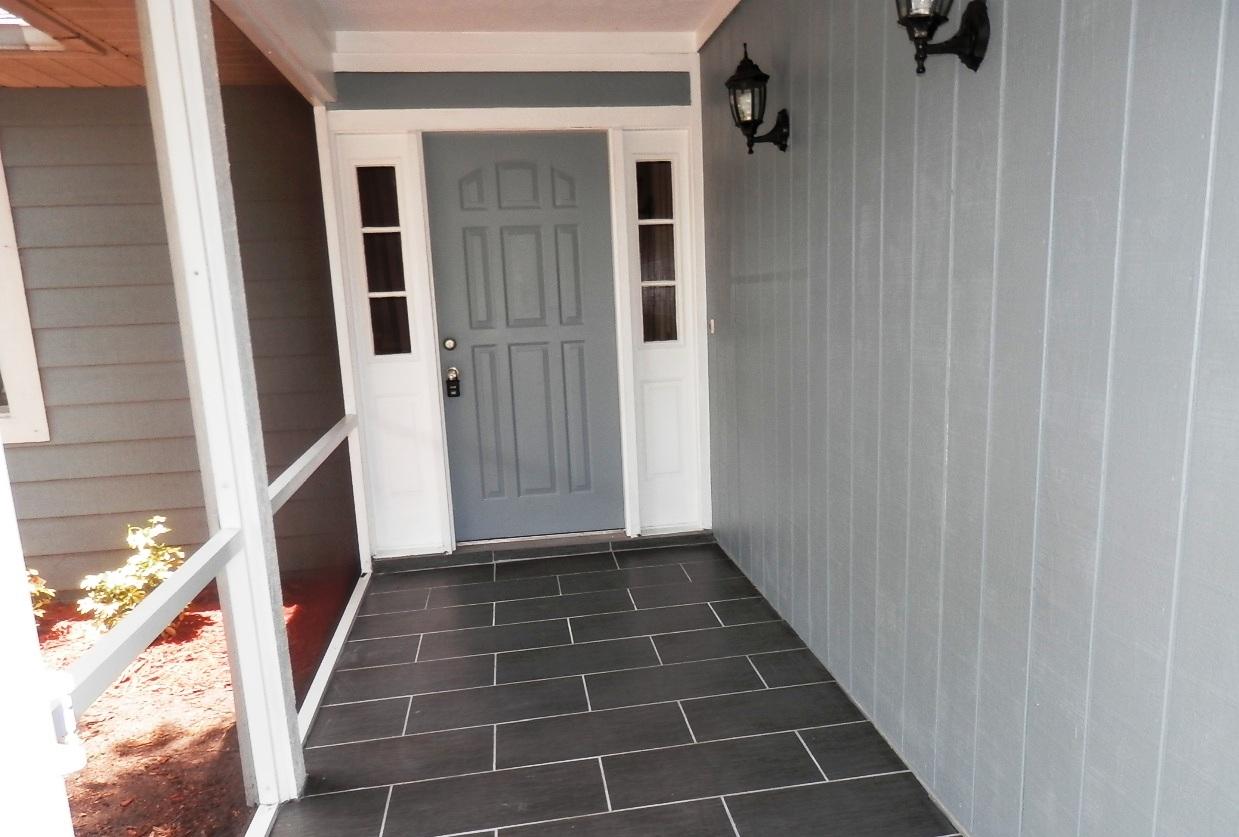2252 Southeast Flanders Road Port St. Lucie, FL 34952 - Photo 9 of 24 SCREENED FRONT ENTRY WITH TILE