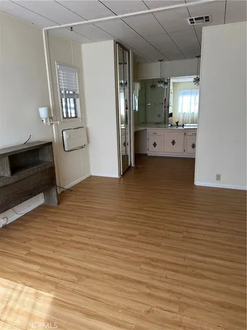 a view of a livingroom with wooden floor and staircase