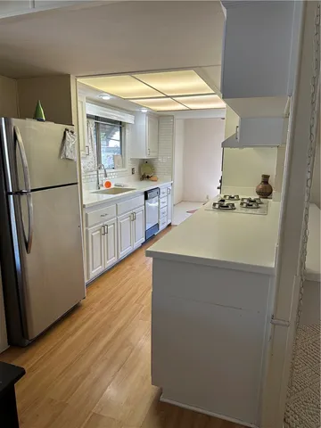 a kitchen with stainless steel appliances a sink and cabinets