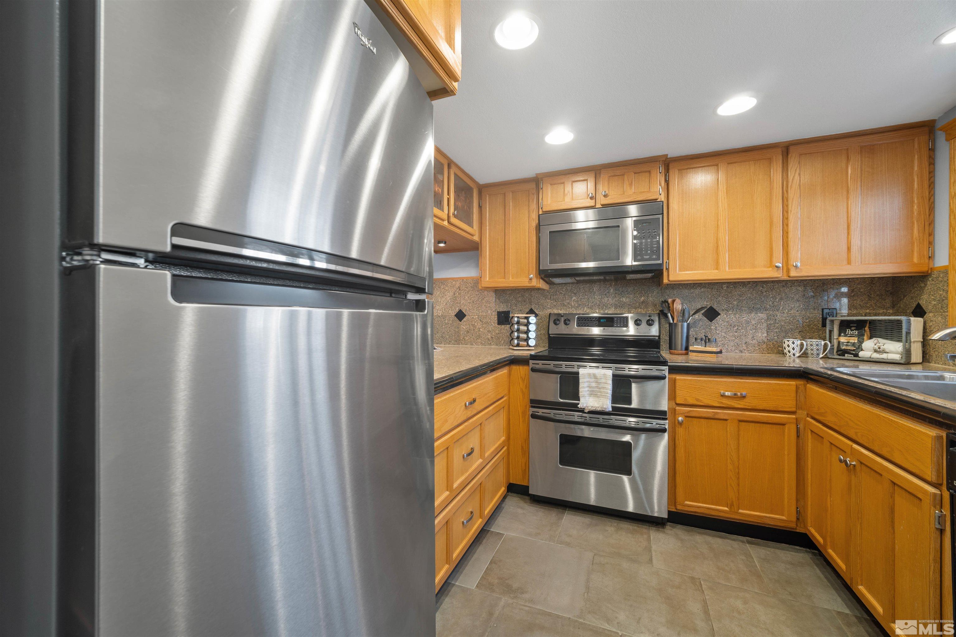 174 Mary Street Reno, NV 89509 - Photo 3 of 28 a kitchen with stainless steel appliances a refrigerator sink and microwave