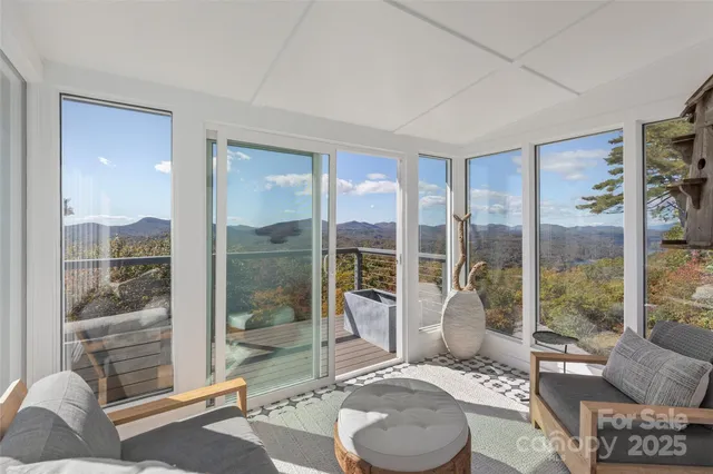 a living room with furniture and a floor to ceiling window