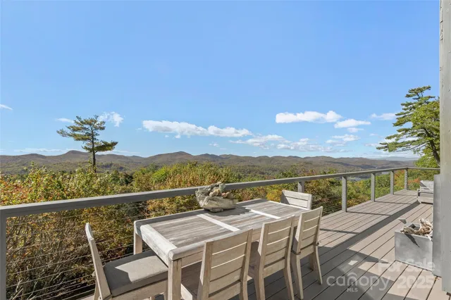 a view of a balcony with mountain view and wooden floor