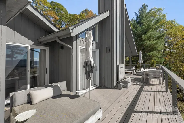 a balcony with furniture and a potted plant