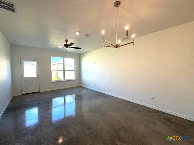 a view of a livingroom with a ceiling fan and window