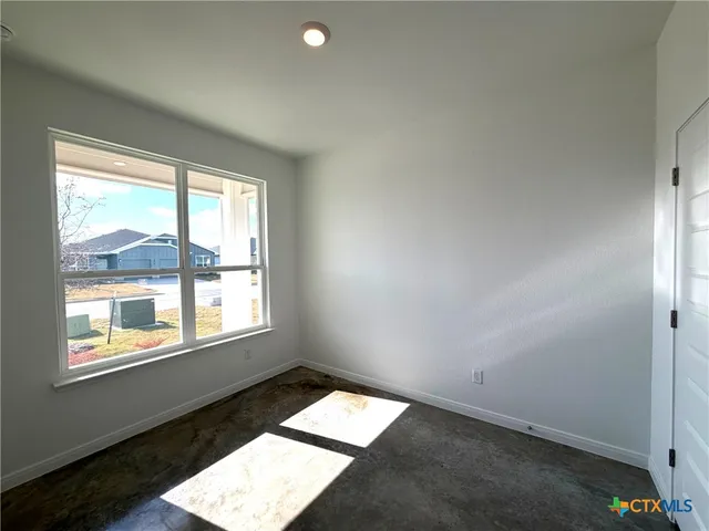 a bathroom with a granite countertop toilet sink and mirror