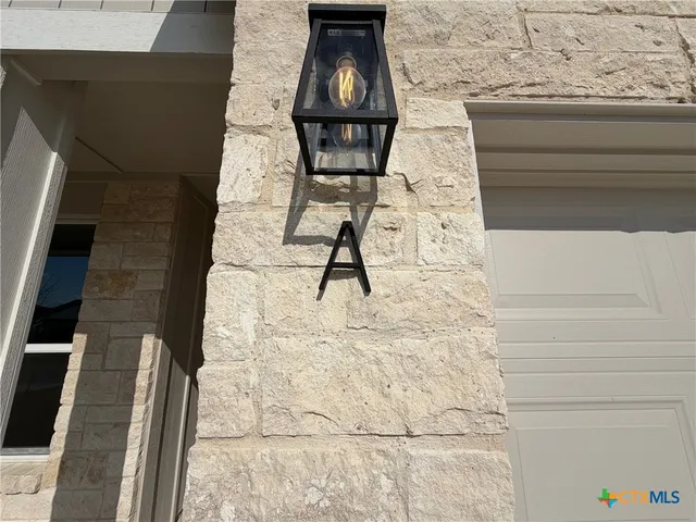 a kitchen with stainless steel appliances granite countertop a sink a stove a refrigerator cabinets and a window