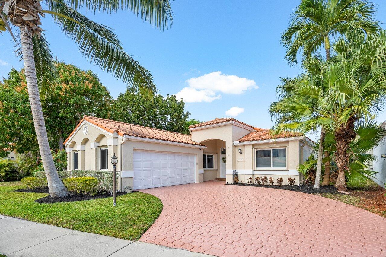 8541 Nadmar Avenue Boca Raton, FL 33434 - Photo 1 of 39 a front view of a house with a garden
