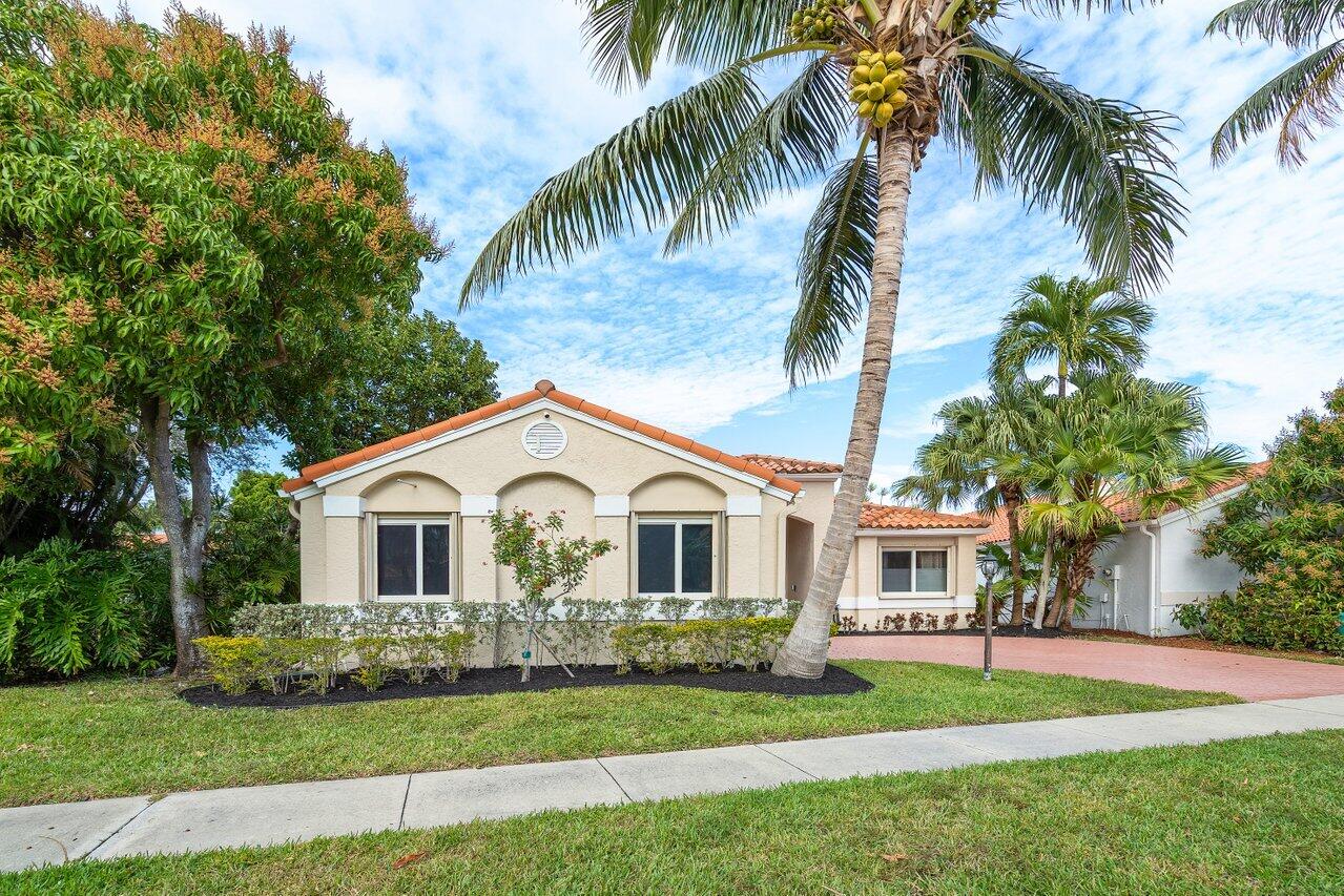 8541 Nadmar Avenue Boca Raton, FL 33434 - Photo 2 of 39 a view of a white house with a big yard and palm trees