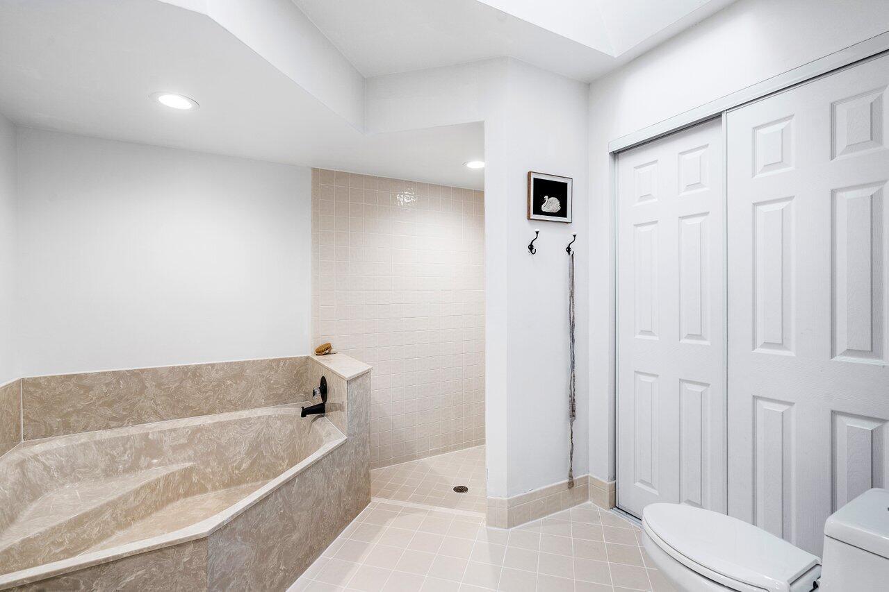 8541 Nadmar Avenue Boca Raton, FL 33434 - Photo 24 of 39 a bathroom with a tub shower and toilet