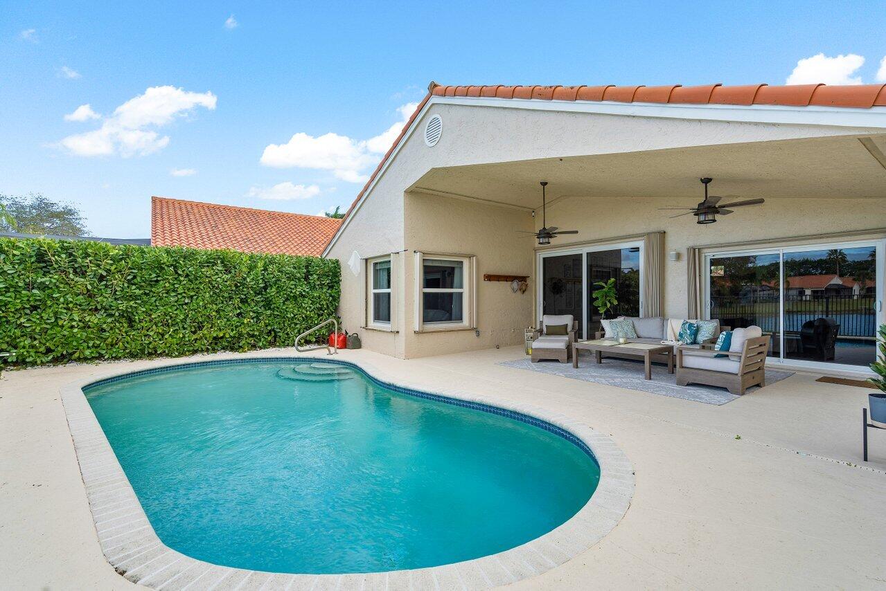 8541 Nadmar Avenue Boca Raton, FL 33434 - Photo 27 of 39 a view of a house with swimming pool and porch