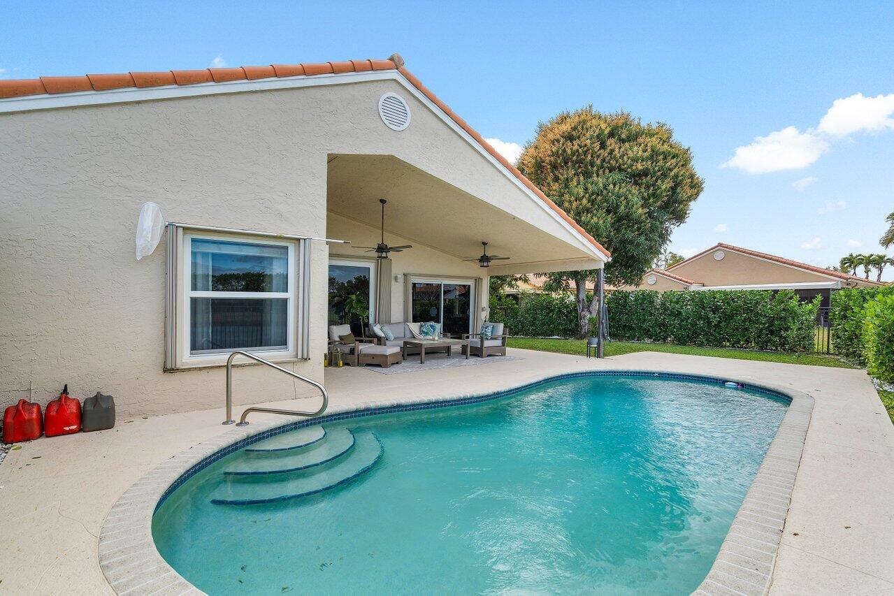 8541 Nadmar Avenue Boca Raton, FL 33434 - Photo 28 of 39 a swimming pool with outdoor seating and yard