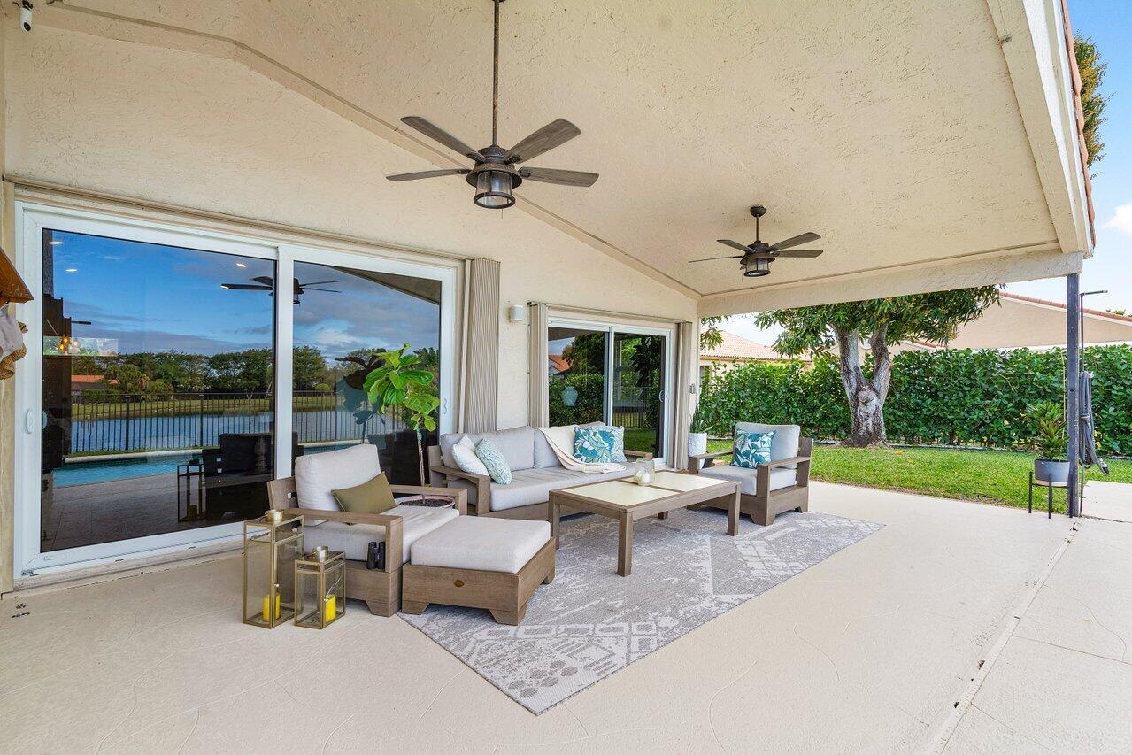 8541 Nadmar Avenue Boca Raton, FL 33434 - Photo 29 of 39 a living room with furniture and a floor to ceiling window