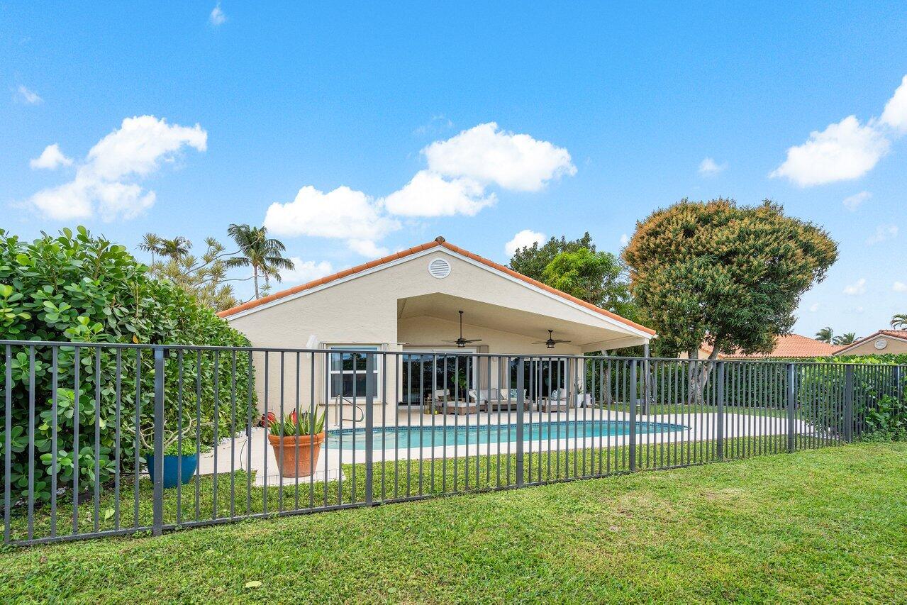 8541 Nadmar Avenue Boca Raton, FL 33434 - Photo 33 of 39 a view of a house with a yard and a garden