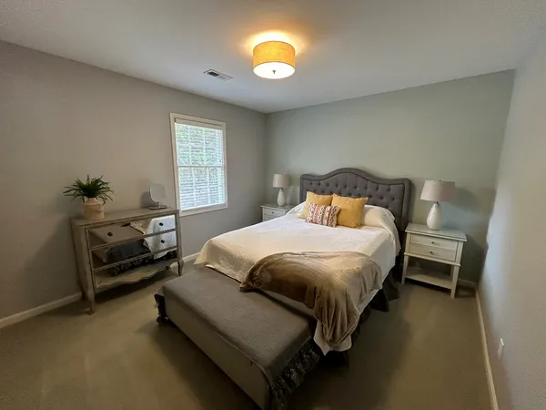 a bedroom with a bed and a lamp