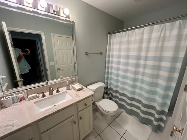 a bathroom with a double vanity sink mirror and toilet
