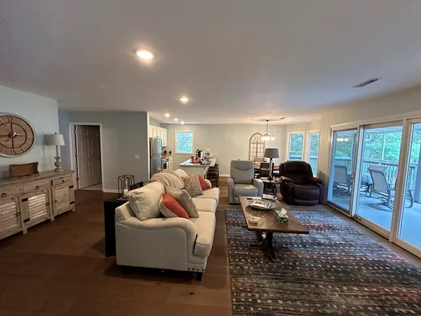 a living room with furniture ceiling fan and a rug