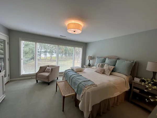 a bedroom with a bed and glass window