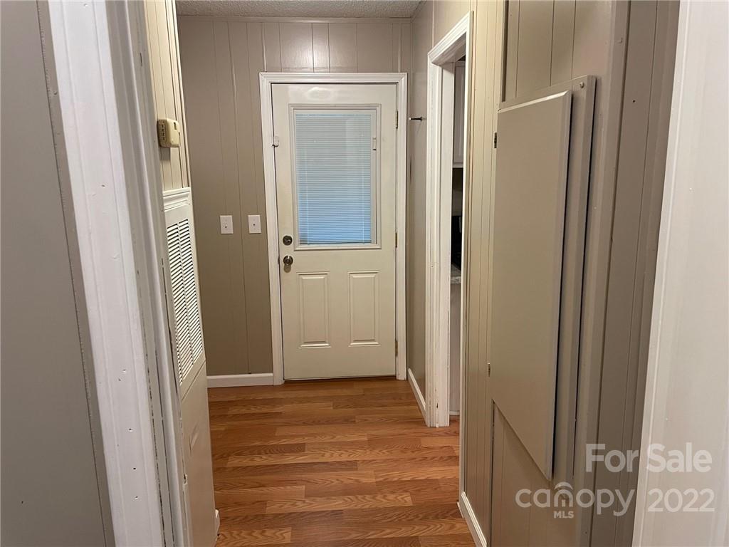 1682 Laughter Road Mill Spring, NC 28756 - Photo 19 of 24 a view of a hallway with wooden floor