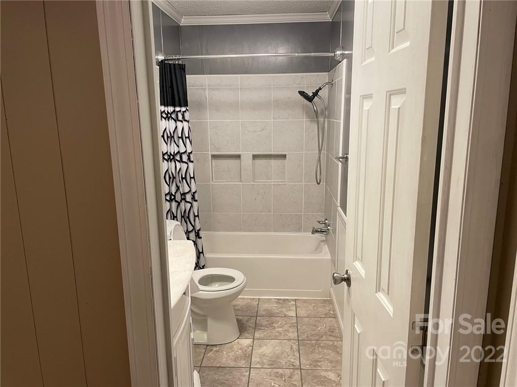 1682 Laughter Road Mill Spring, NC 28756 - Photo 23 of 24 a bathroom with a bathtub and a shower