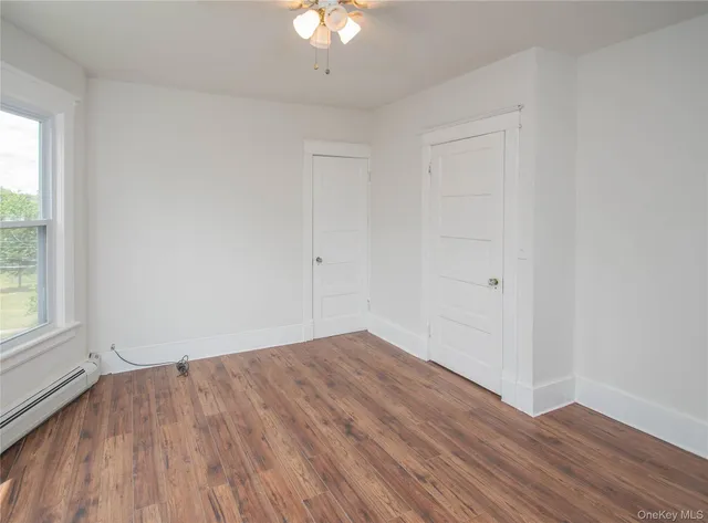 wooden floor in an empty room with a window