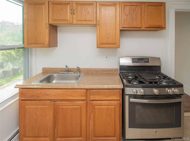a stove top oven sitting inside of a kitchen