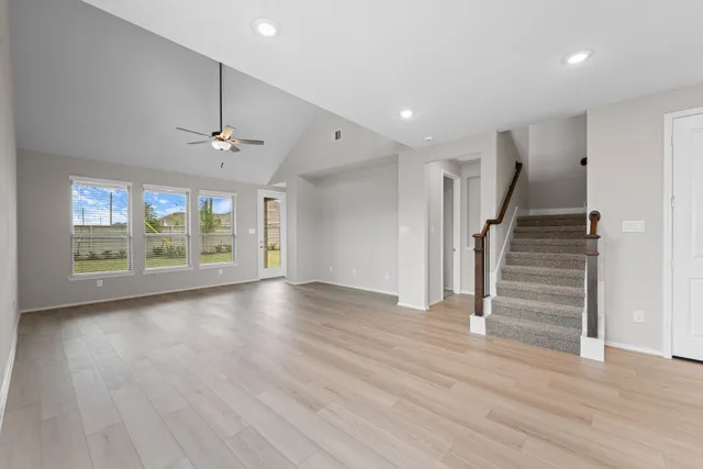 a bedroom with a large bed and a potted plant