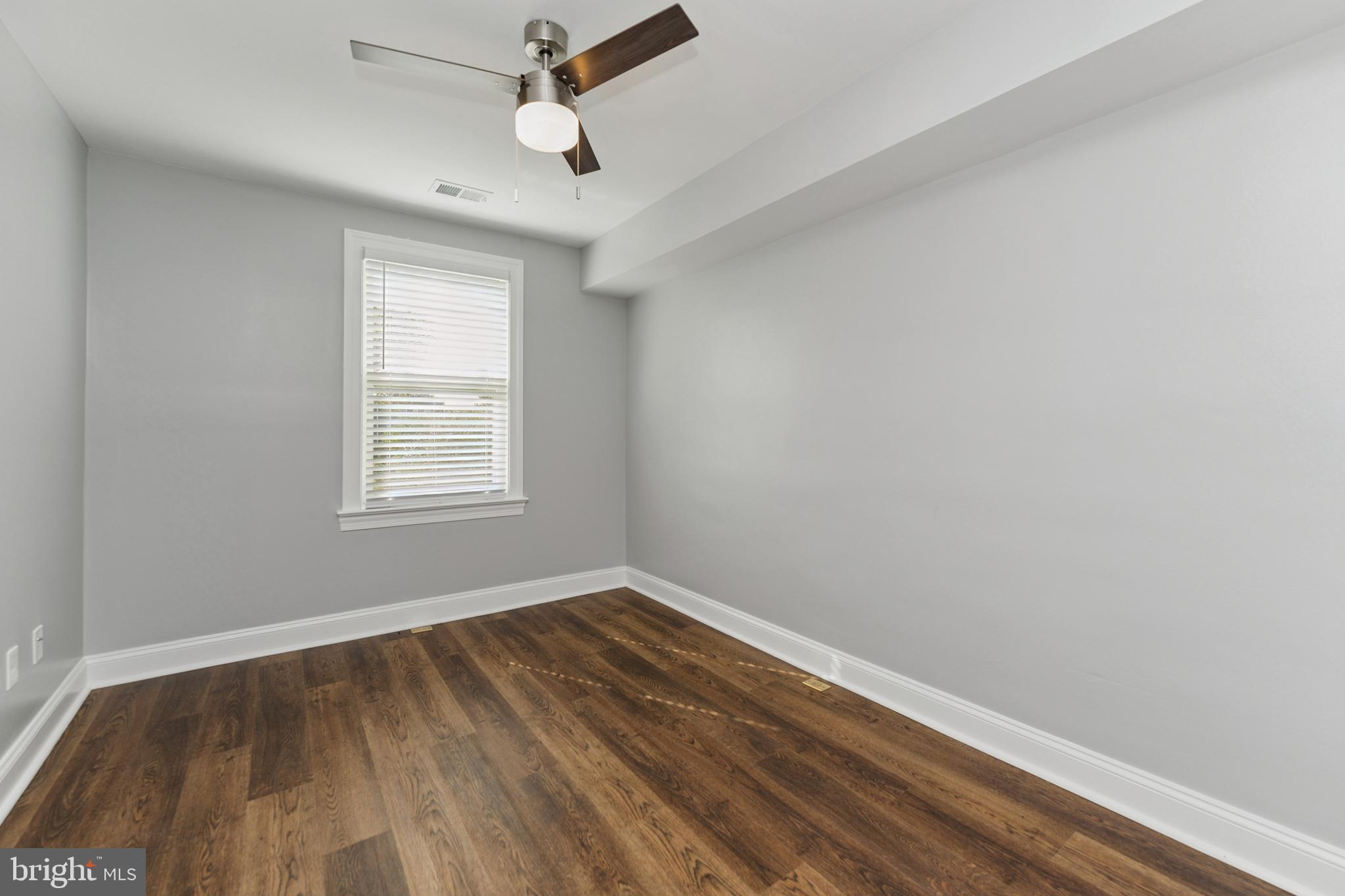 2021 E Street Northeast, Unit 4 Washington, DC 20002 - Photo 11 of 15 wooden floor in an empty room with a window
