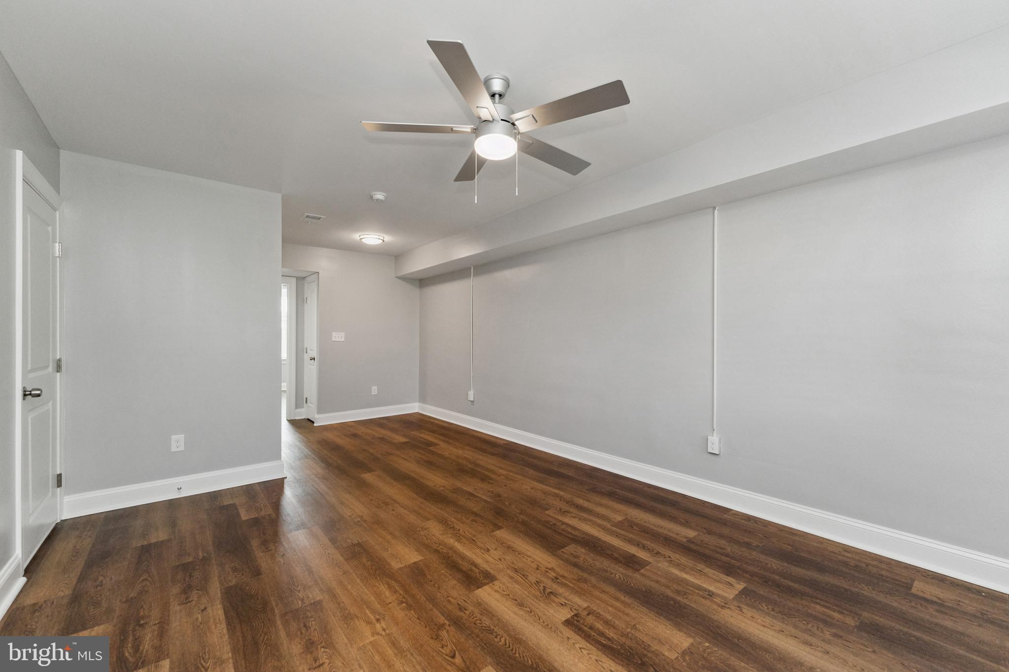 2021 E Street Northeast, Unit 4 Washington, DC 20002 - Photo 2 of 15 a view of an empty room with wooden floor and a ceiling fan