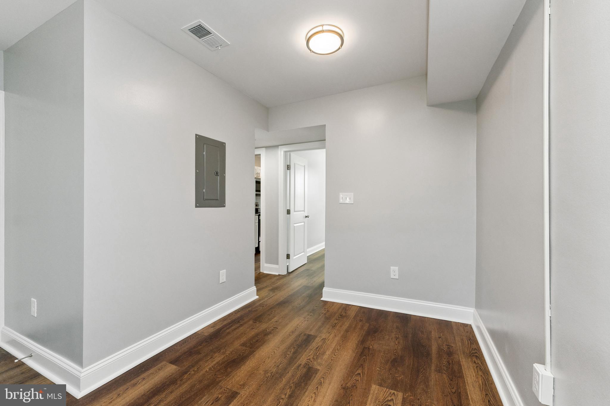 2021 E Street Northeast, Unit 4 Washington, DC 20002 - Photo 5 of 15 an empty room with wooden floor and entrance
