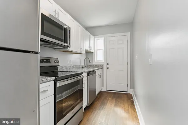 a kitchen with a stove microwave and sink