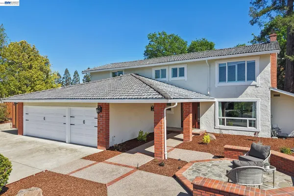 a view of a house with backyard tub and couches
