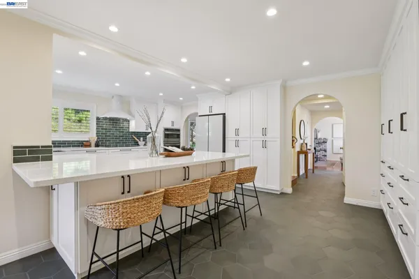a large white kitchen with cabinets
