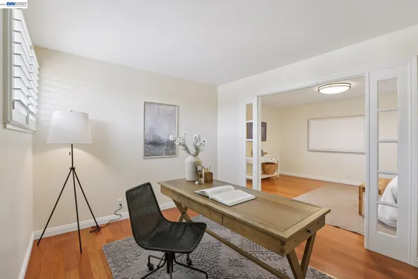 a bathroom with a toilet a sink a mirror and vanity
